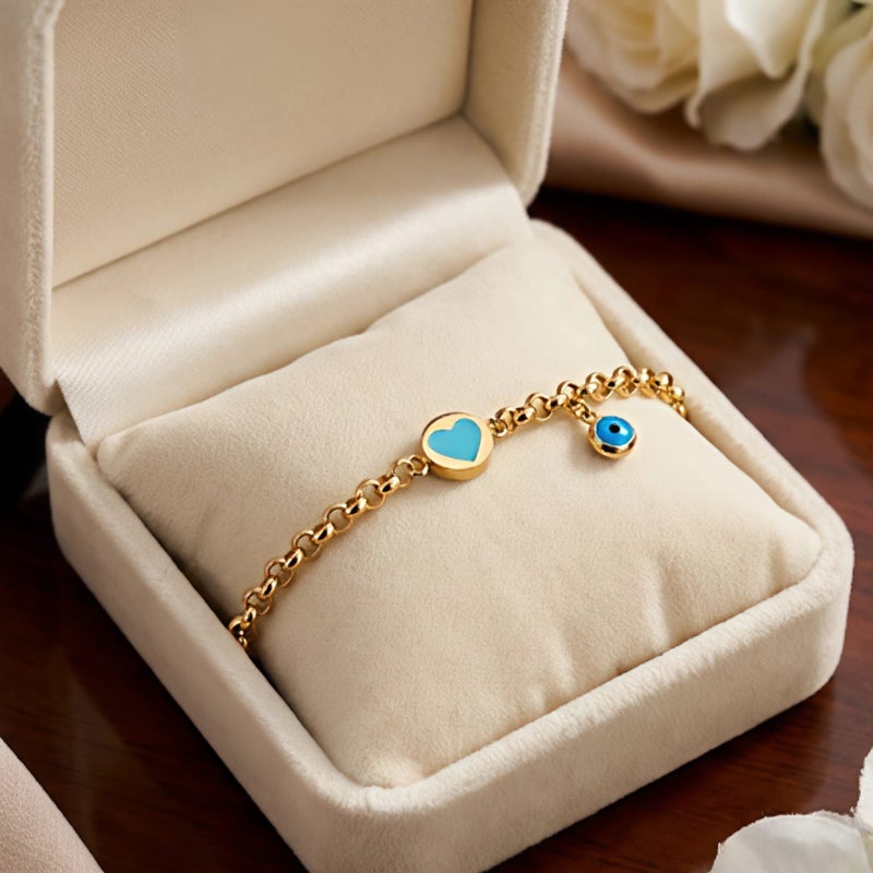 A gold-tone bracelet crafted from rust-resistant stainless steel, featuring a delicate turquoise heart design and a blue "eye" charm. Its modern design complements any look, and it has an adjustable clasp for a perfect fit. - Image 5
